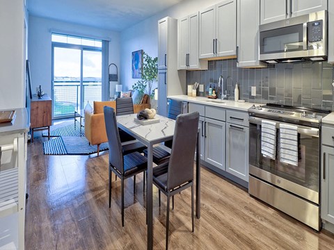 a kitchen and dining room with a table and chairs